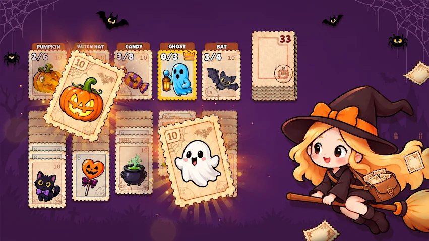 The Halloween table: pumpkin, candy, ghost and bat stamps, with a witch flying past on a broom